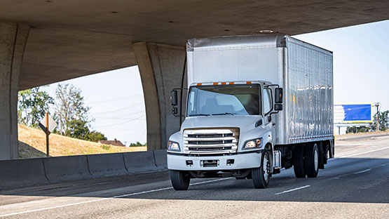 A truck driver driving a truck on the highway