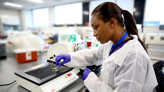 Histologic technician retrieving slides from refrigerator