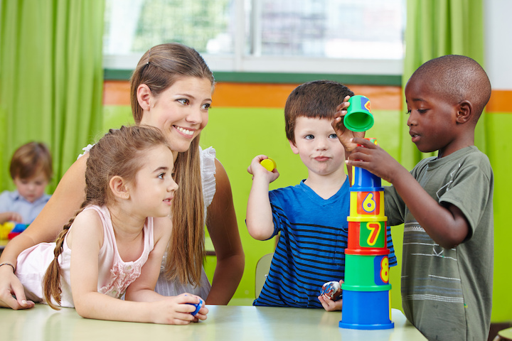 Teacher with toddlers at a table