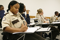 School of Justice student in  classroom, taking notes.