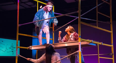 Three woman acting on stage