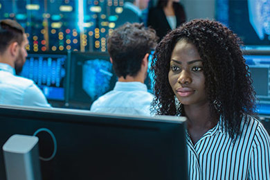 Woman sitting in front of computer monitor