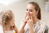 Woman helping a kid with speech problems