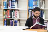 Student reading a book at the library