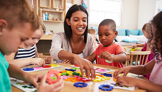 teacher surrounded by students in classroom