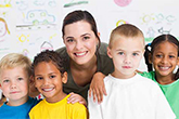 Teacher with four students posing for camera