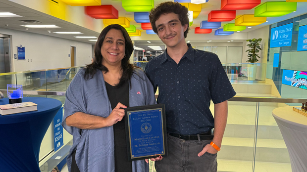 Alessandro Santoro and Dr. Trinidad Argüelles standing holding an award